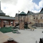A view of the green and beige playground at Ironwood Heights